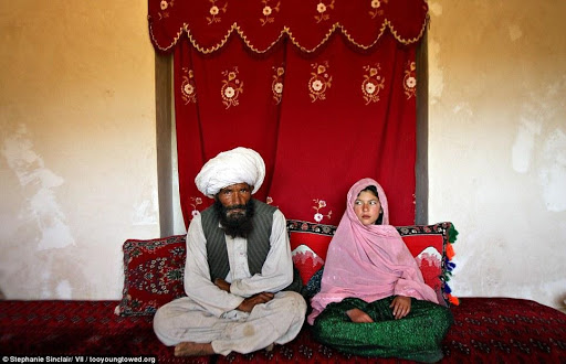 Disturbing: Faiz, 40 (left), and Ghulam (right), 11, sit in her home prior to their wedding in the rural Damarda Village, Afghanistan on September 11, 2005